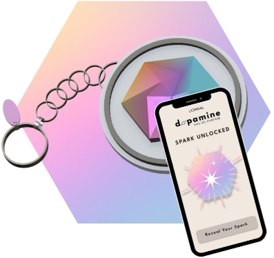 The Dopamine NFC keychain beside a phone showing the app's Spark Unlocked screen with a Reveal Your Spark button